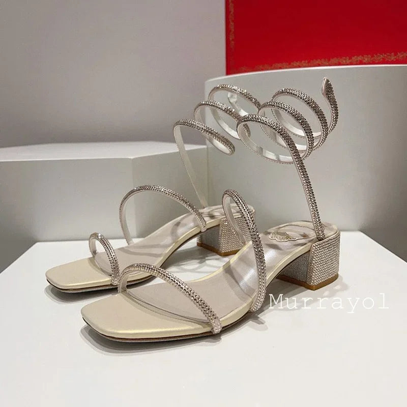 Women's rhinestone square heel sandals by MAIRA'S COLLECTIONS with elastic ankle strap and stylish design.