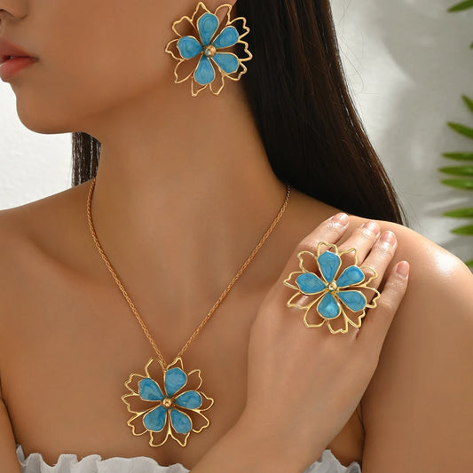 Bohemian floral jewelry set by MAIRA'S COLLECTIONS featuring earrings, necklace, and bracelet with colorful floral designs.