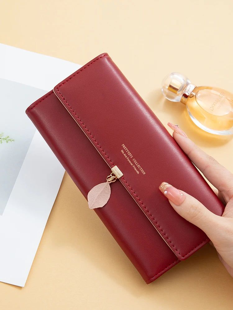 Women's PU leather tri-fold bag by MAIRA'S COLLECTIONS, showing the sleek black exterior and compact design.