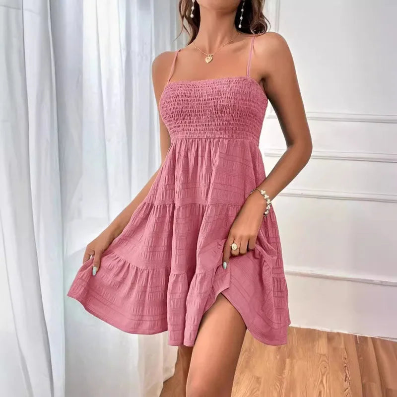 Women's smocked mini dress from MAIRA'S COLLECTIONS featuring a fitted bodice and flared skirt, perfect for casual or summer wear.