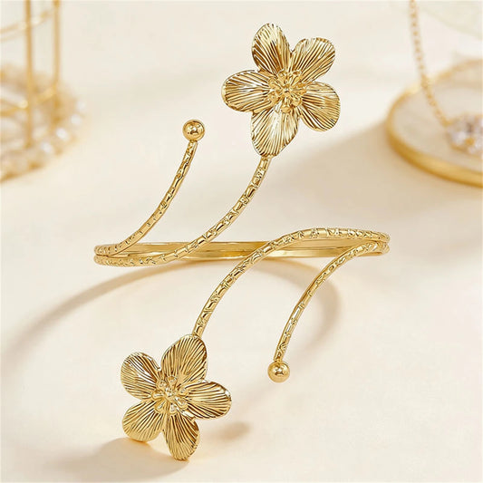 Gold flower boho arm cuff from MAIRA'S COLLECTIONS featuring intricate floral design and adjustable band for stylish wear.