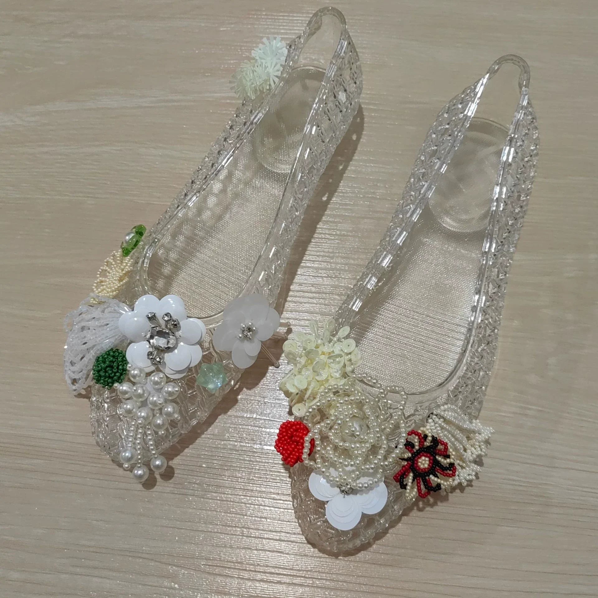 Women's crystal jelly flats by MAIRA'S COLLECTIONS featuring pointed toe summer sandals with transparent, glossy finish and crystal accents.