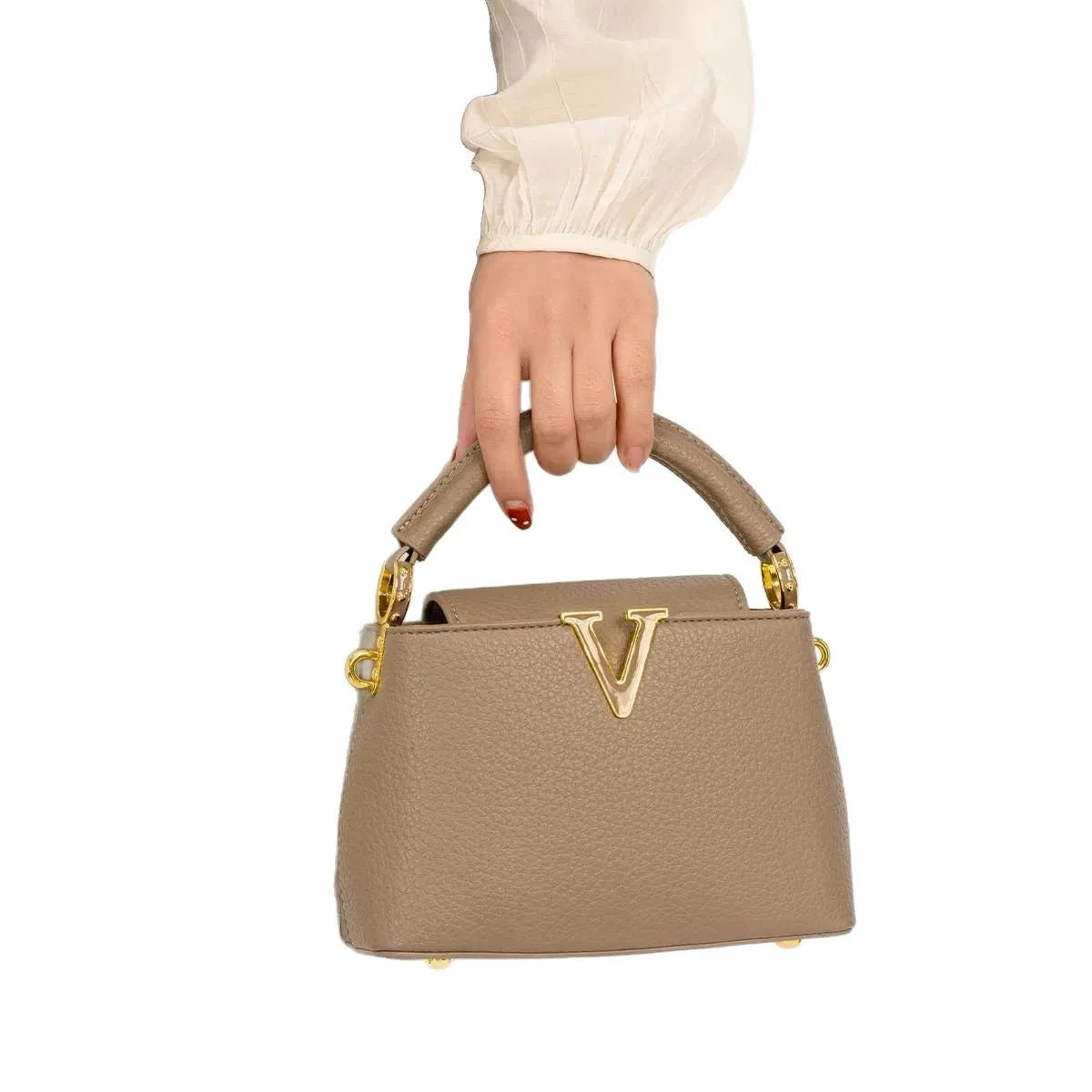 Women's luxury leather crossbody bag by MAIRA'S COLLECTIONS, showing a sleek black leather design with a shoulder strap.
