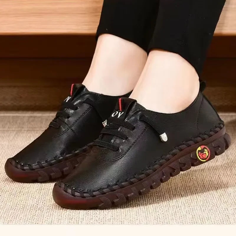 Women's leather sneakers by MAIRA'S COLLECTIONS with lace-up design, casual comfort shoes, black leather, and stylish details.