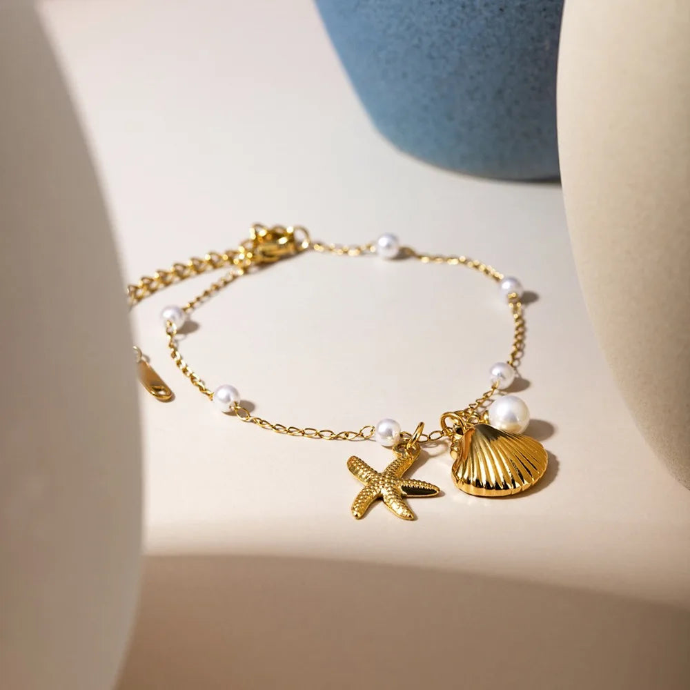 Bohemian starfish shell pearl bracelet from MAIRA'S COLLECTIONS featuring starfish charms and pearl beads on a delicate bracelet.