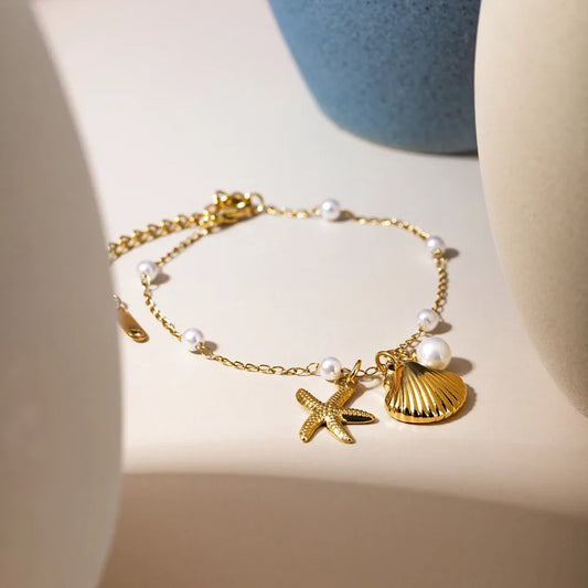 Bohemian starfish shell pearl bracelet from MAIRA'S COLLECTIONS featuring starfish charms and pearl beads on a delicate bracelet.