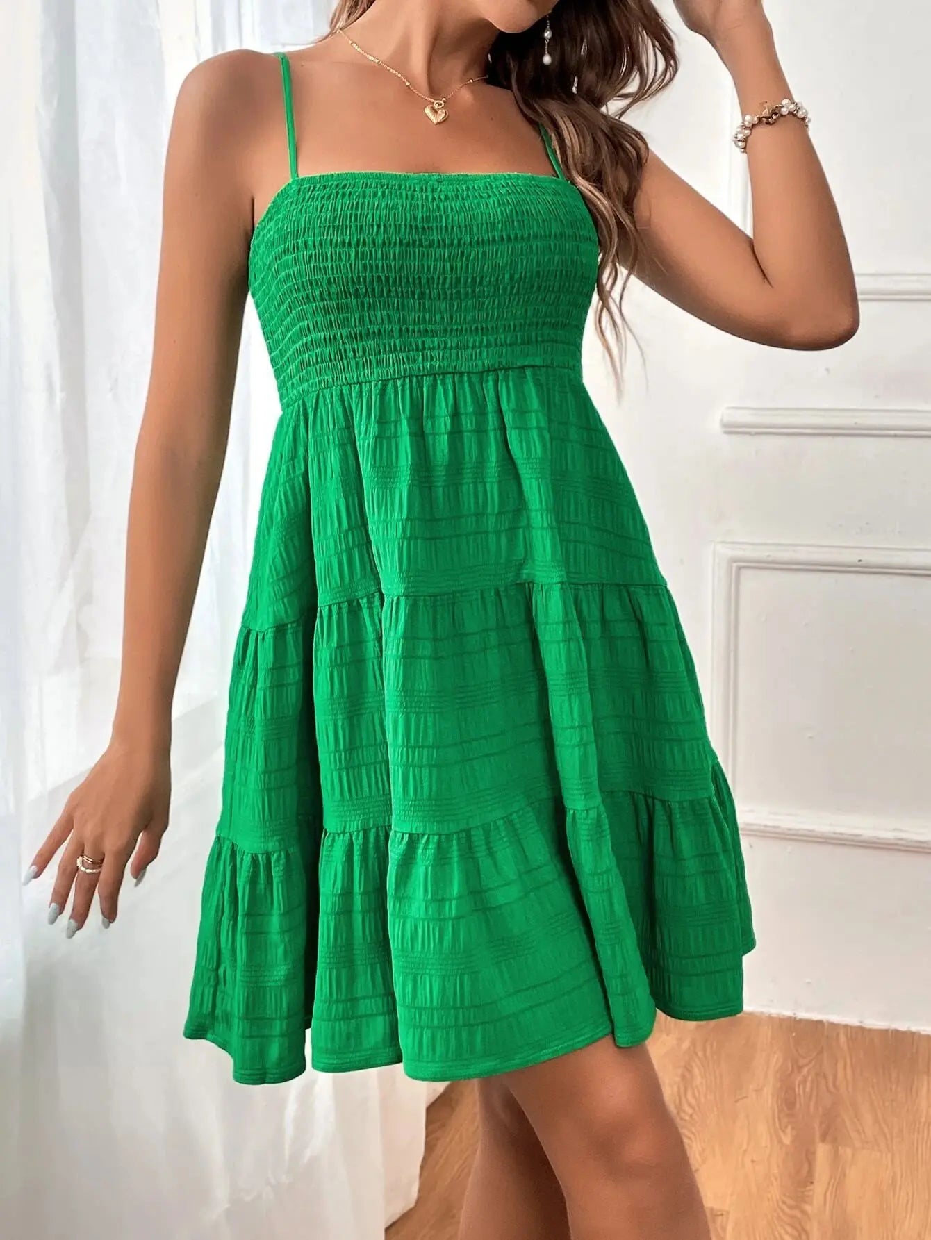 Women's smocked mini dress by MAIRA'S COLLECTIONS featuring a fitted bodice and ruffled hem in a stylish, casual design.