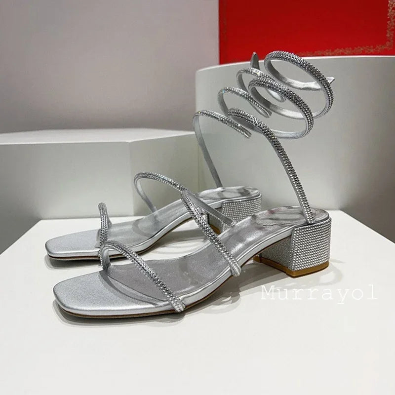 Women's rhinestone square heel sandals with elastic ankle strap by MAIRA'S COLLECTIONS, showcasing elegant design and sparkling details.