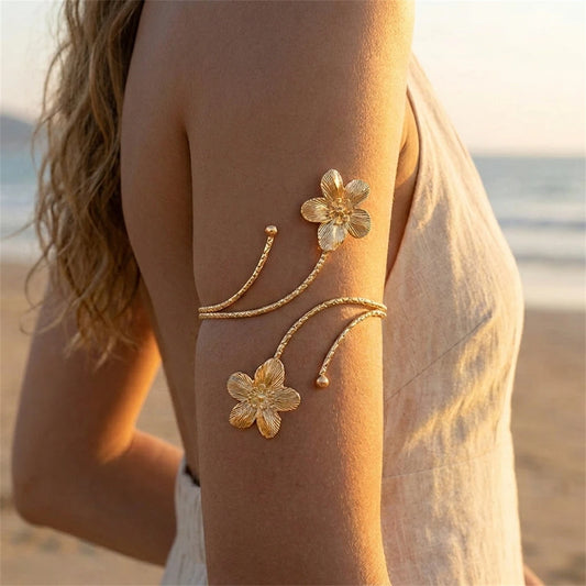 Gold flower arm cuff from MAIRA'S COLLECTIONS featuring boho style with intricate floral design, stylish and adjustable jewelry piece.