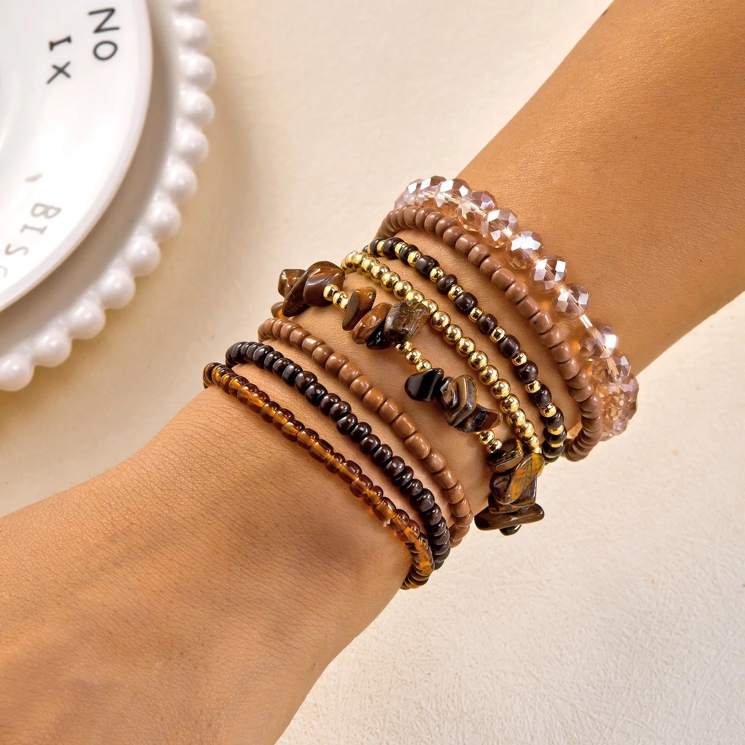 Set of 10 bohemian wood beaded bracelets by MAIRA'S COLLECTIONS with natural wood beads and boho-style designs.