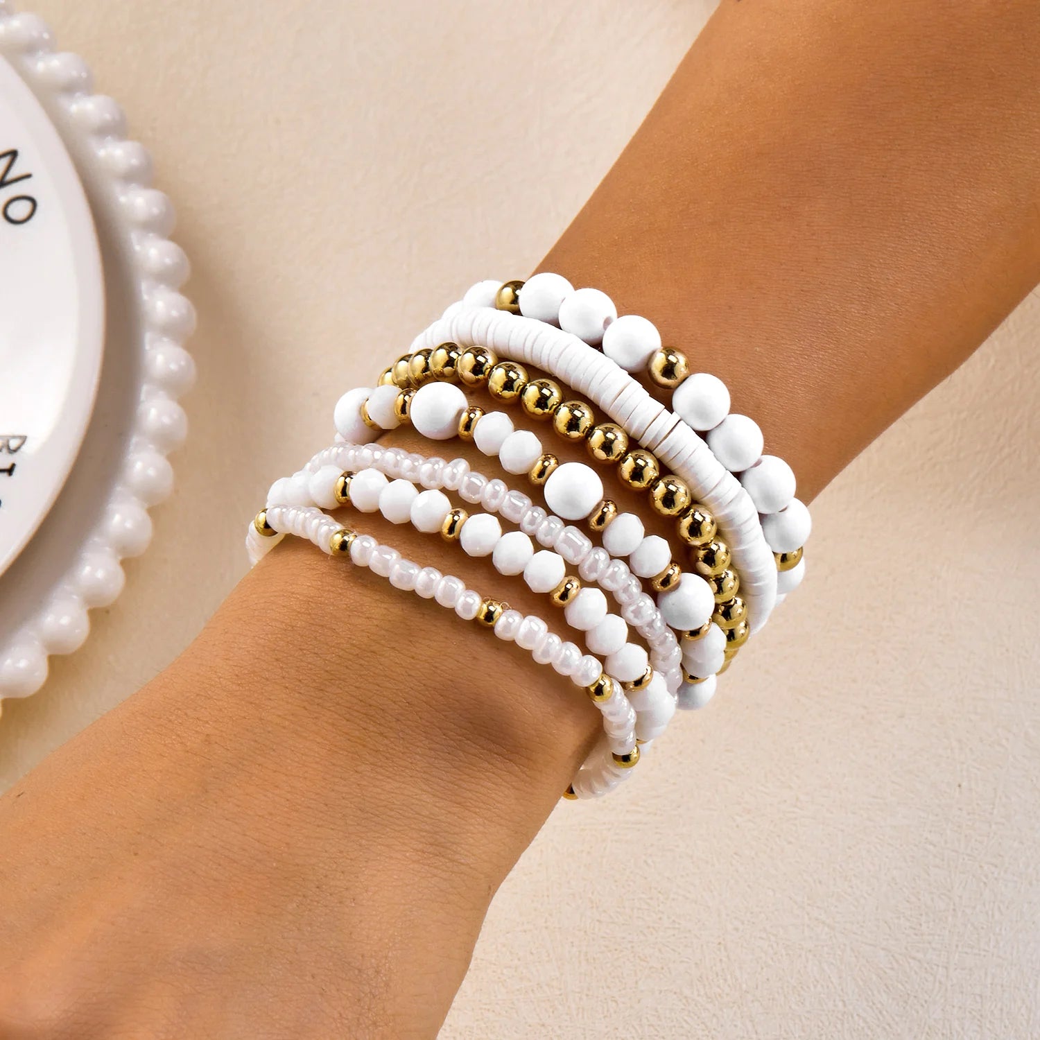 Set of 10 bohemian wood beaded bracelets from MAIRA'S COLLECTIONS, featuring natural wooden beads and stylish, layered design.