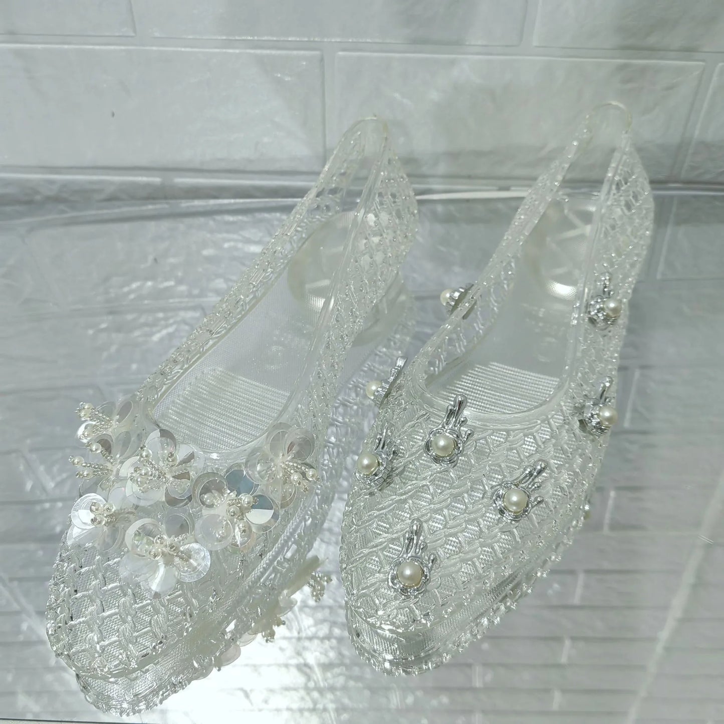 Women's crystal jelly flats by MAIRA'S COLLECTIONS featuring pointed toe design and summer sandal style with transparent, glossy material.