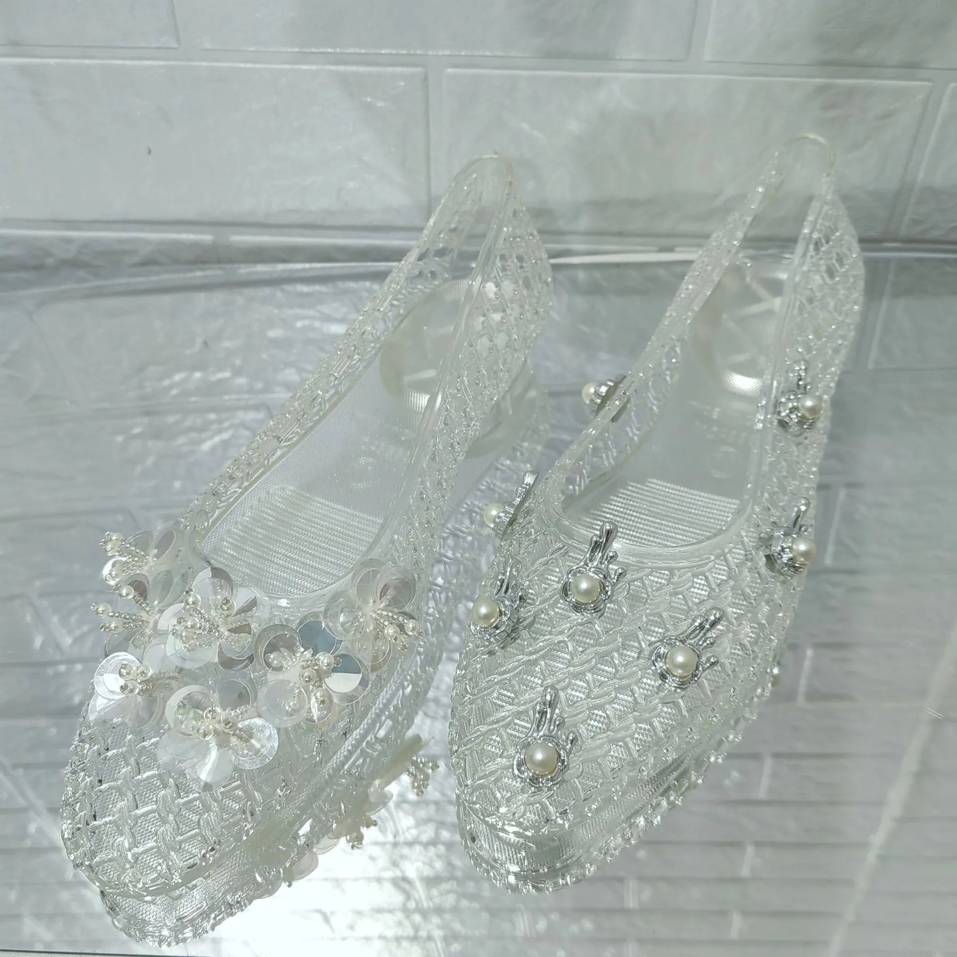 Women's crystal jelly flats by MAIRA'S COLLECTIONS featuring pointed toe design and summer sandal style with transparent, glossy material.