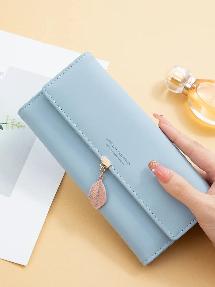 Women's PU leather tri-fold bag by MAIRA'S COLLECTIONS, showing the stylish brown leather exterior and fold-over design.