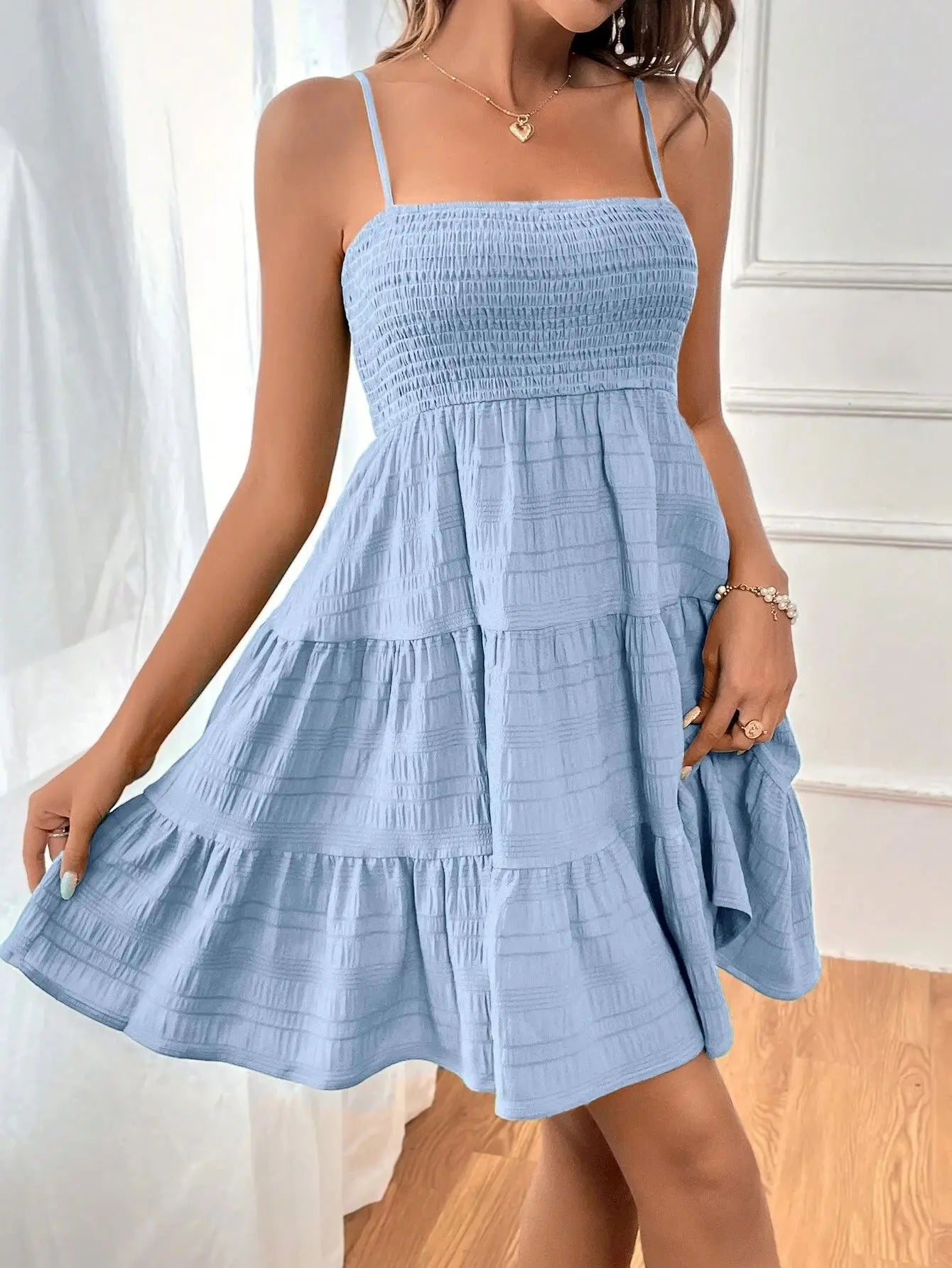 Women's smocked mini dress by MAIRA'S COLLECTIONS featuring a fitted bodice and flowy skirt, shown in a stylish design.