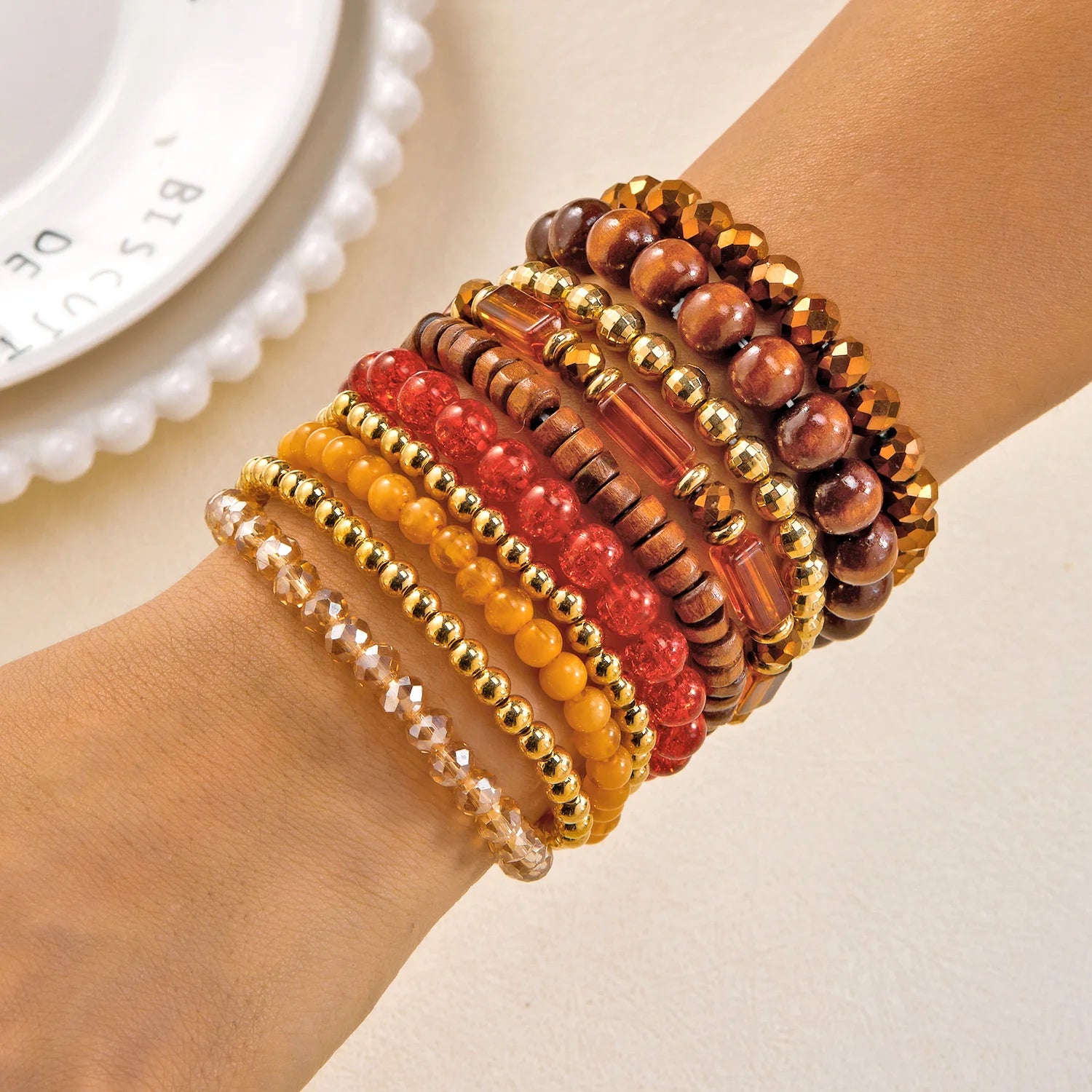 Set of 10 bohemian wood beaded bracelets from MAIRA'S COLLECTIONS with natural wood and intricate bead designs.