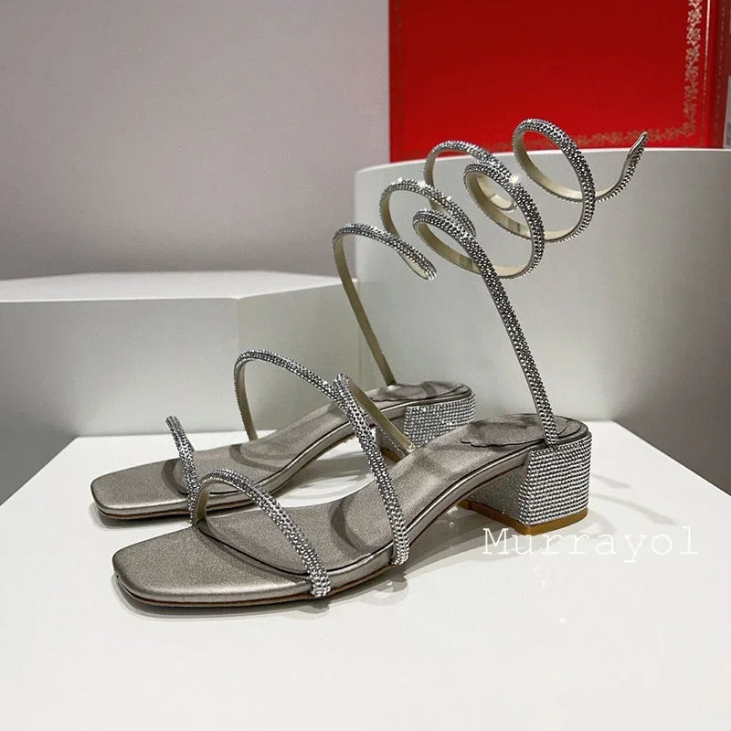 Women's rhinestone square heel sandals with elastic ankle strap by MAIRA'S COLLECTIONS, featuring sparkling embellishments and stylish design.