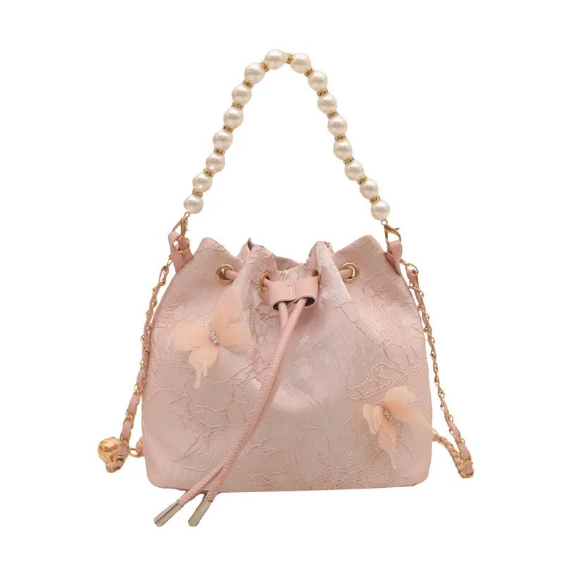 Women's butterfly bucket shoulder bag by MAIRA'S COLLECTIONS featuring a stylish butterfly design and adjustable shoulder strap.