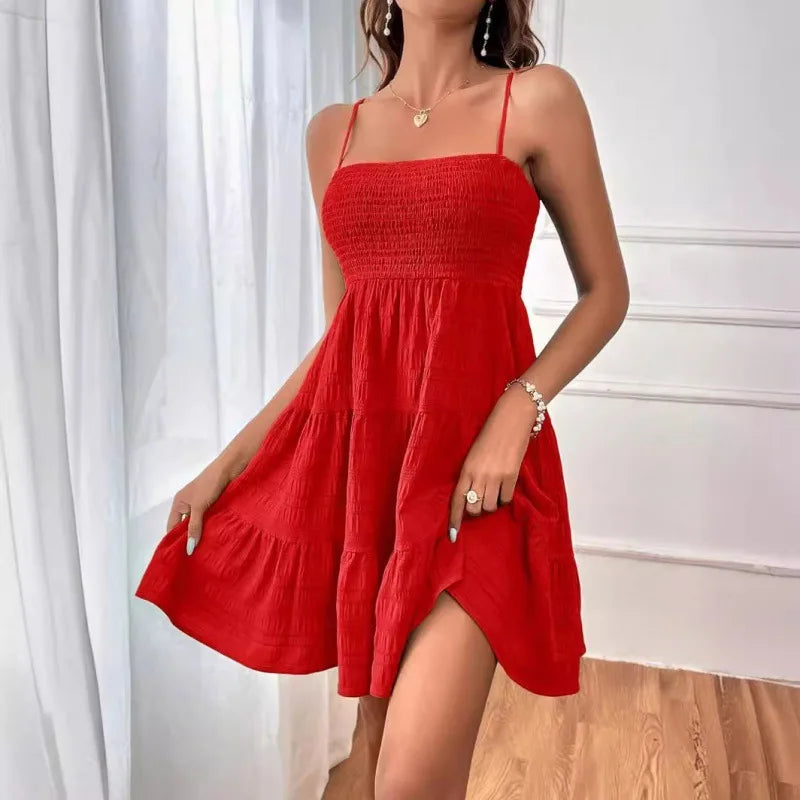 Women's smocked mini dress by MAIRA'S COLLECTIONS, featuring a fitted bodice and short sleeves, displayed on a hanger.