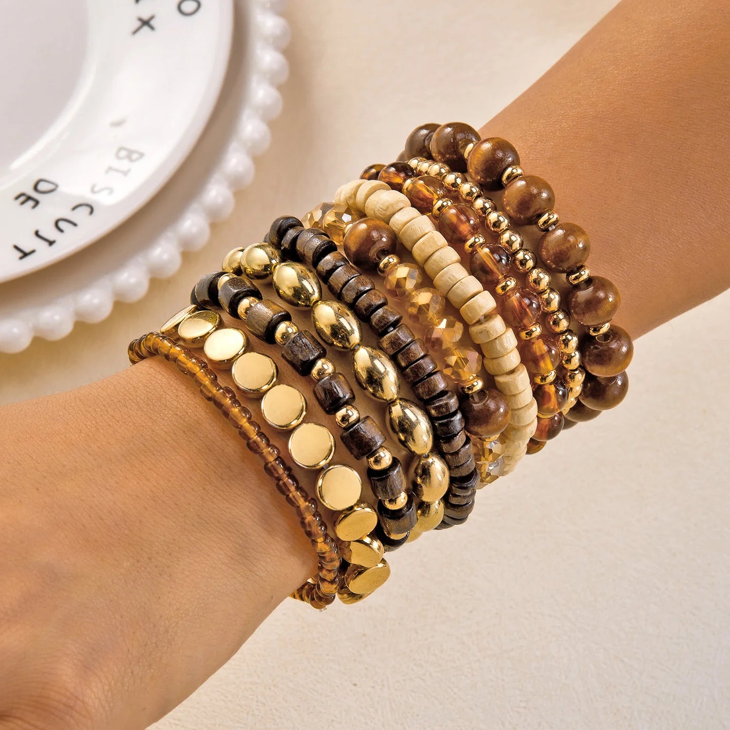 Set of 10 bohemian wood beaded bracelets from MAIRA'S COLLECTIONS featuring natural wooden beads and adjustable designs.