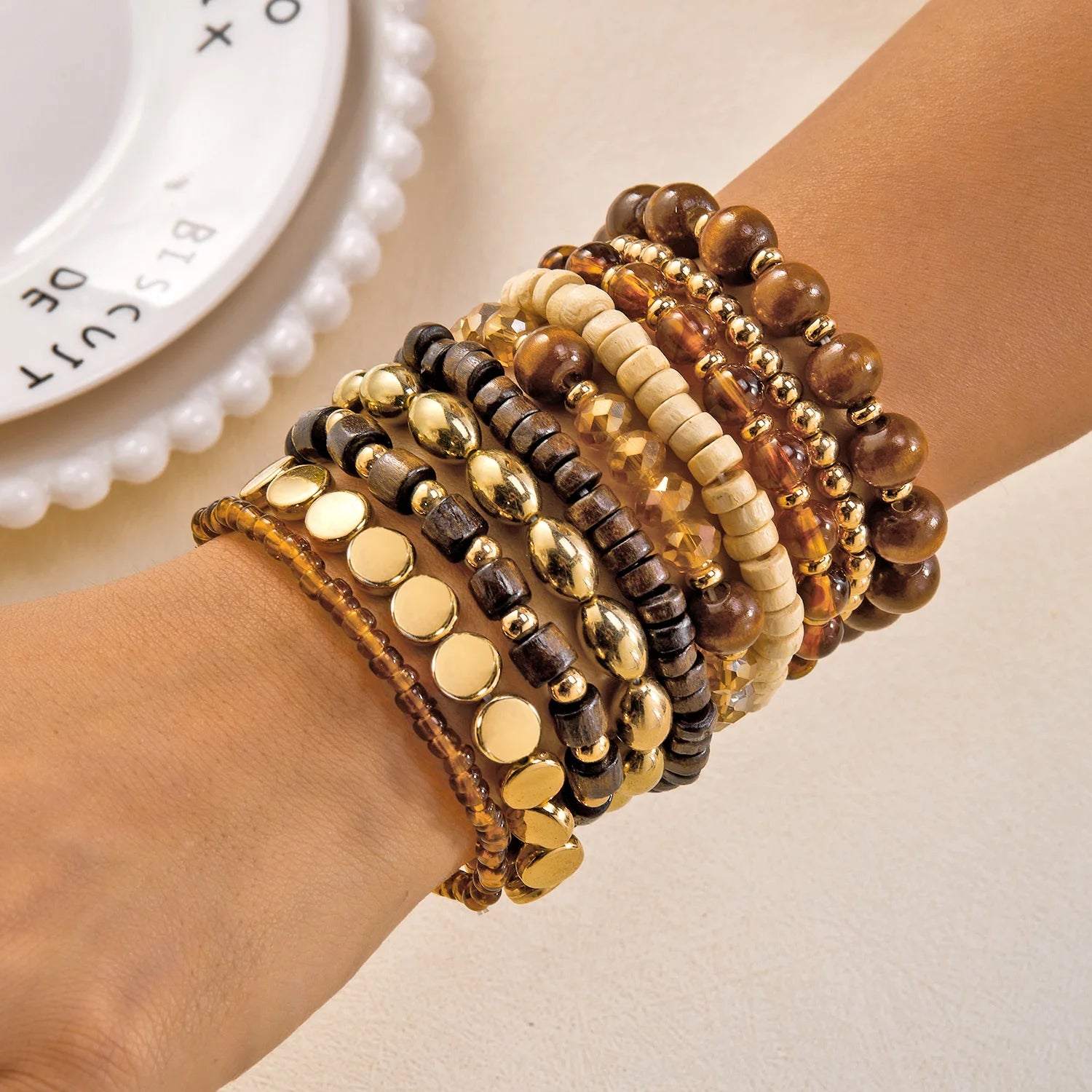 Set of 10 bohemian wood beaded bracelets from MAIRA'S COLLECTIONS featuring natural wooden beads and adjustable designs.