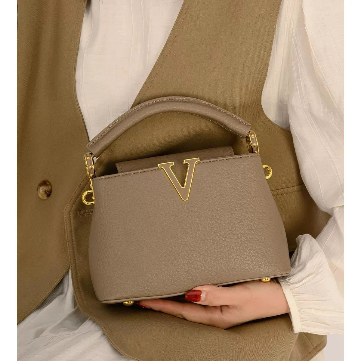 Women's luxury leather crossbody bag from MAIRA'S COLLECTIONS with sleek design and adjustable strap.
