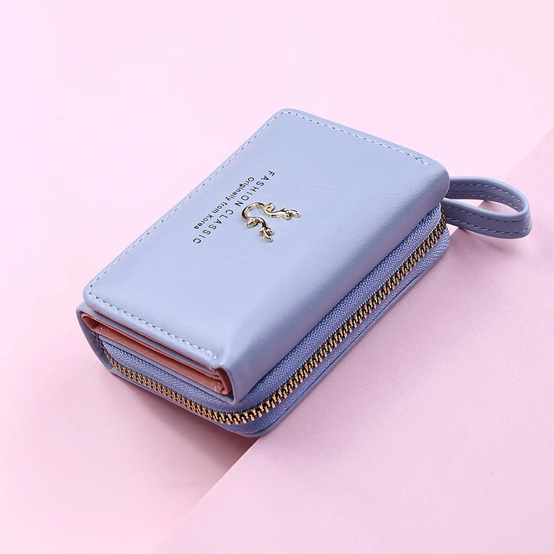 Women's PU leather mini wallet by MAIRA'S COLLECTIONS featuring compact design and card slots, in black with gold accents.