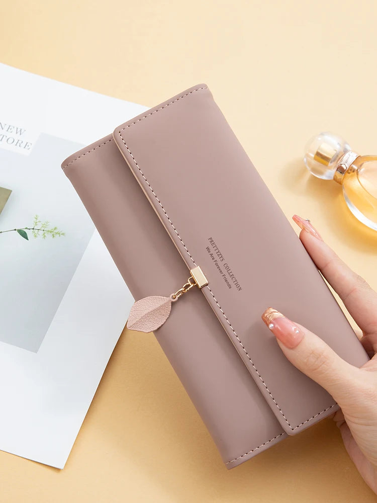 Women's PU leather tri-fold bag by MAIRA'S COLLECTIONS, featuring a sleek design with multiple compartments and stylish finish.