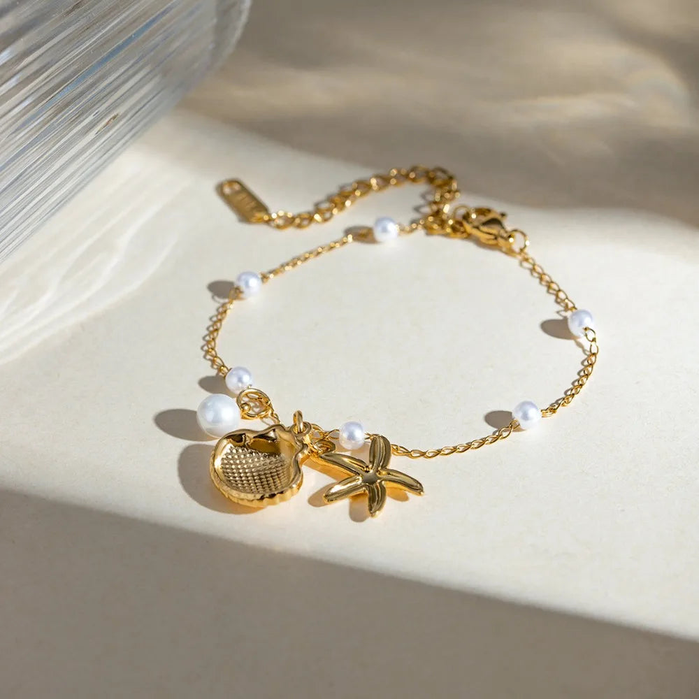 Bohemian starfish shell pearl bracelet with seashell and pearl accents from MAIRA'S COLLECTIONS, showcasing a beach-inspired design.