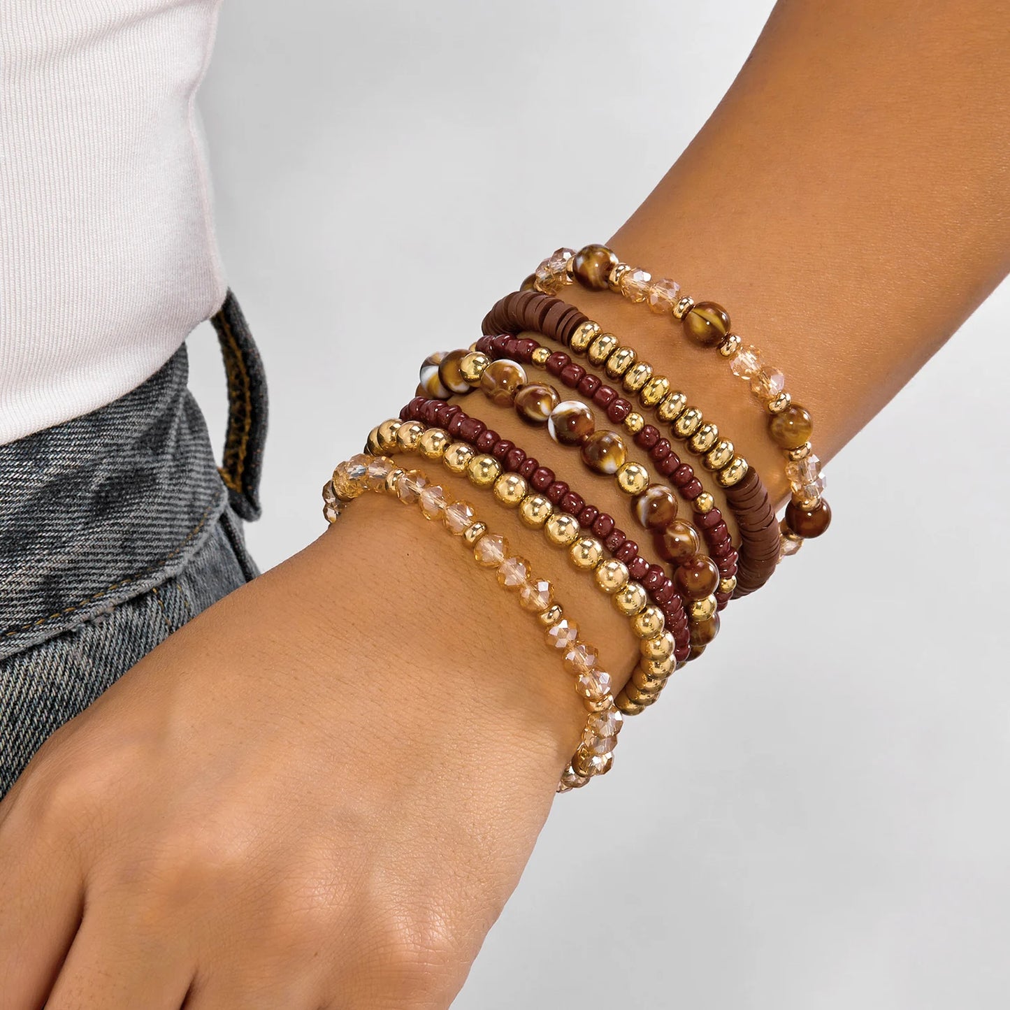 Set of 10 bohemian wood beaded bracelets from MAIRA'S COLLECTIONS featuring natural wooden beads and adjustable designs.