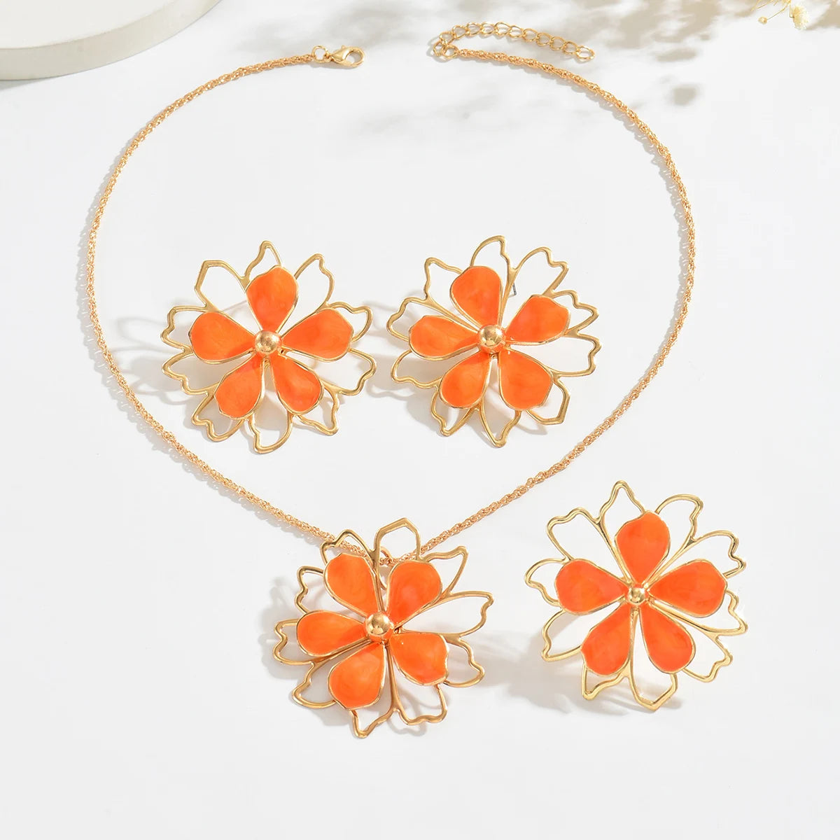 Bohemian floral jewelry set by MAIRA'S COLLECTIONS featuring colorful flower-themed necklace and earrings on a display background.