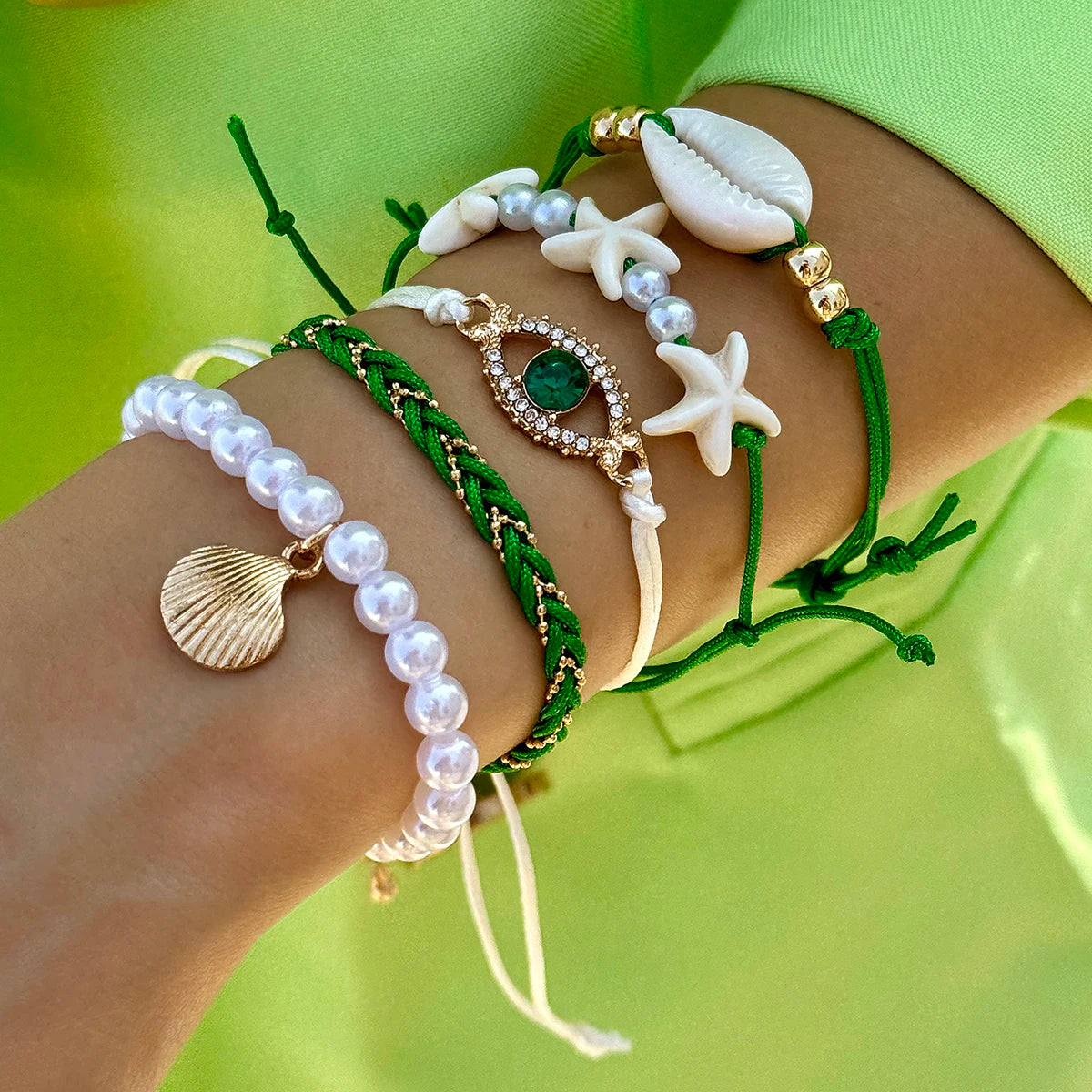 Bohemian pearl bracelet set with five MAIRA'S COLLECTIONS pearl bracelets, featuring mixed sizes and white pearls on elastic bands.