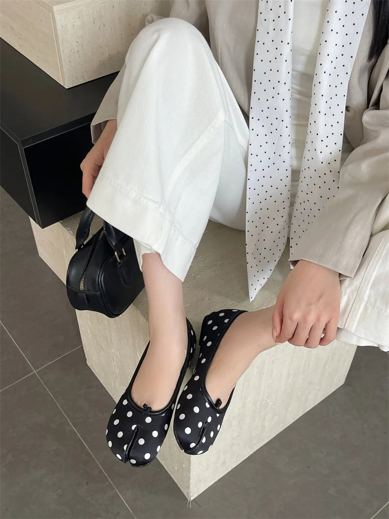 Women's polka dot Tabi flats by MAIRA'S COLLECTIONS featuring split toe design and ballerina shoe style, shown in black and white.