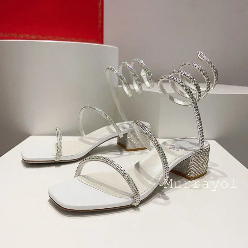 Women's rhinestone square heel sandals with elastic ankle strap by MAIRA'S COLLECTIONS, showcasing stylish footwear with sparkling details.