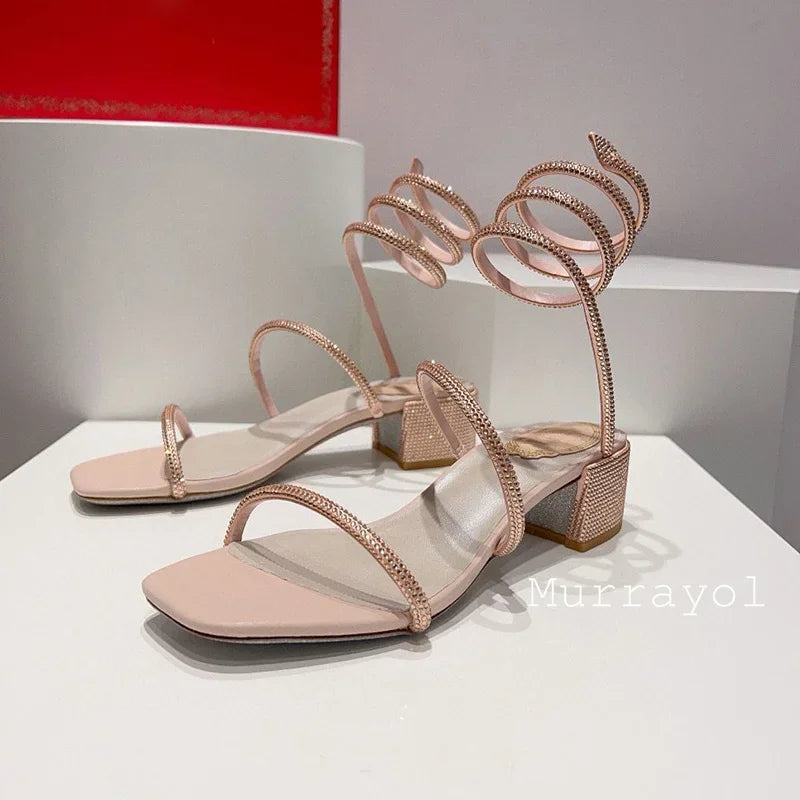 Women's rhinestone square heel sandals with elastic ankle strap by MAIRA'S COLLECTIONS, featuring sparkling embellishments and stylish design.