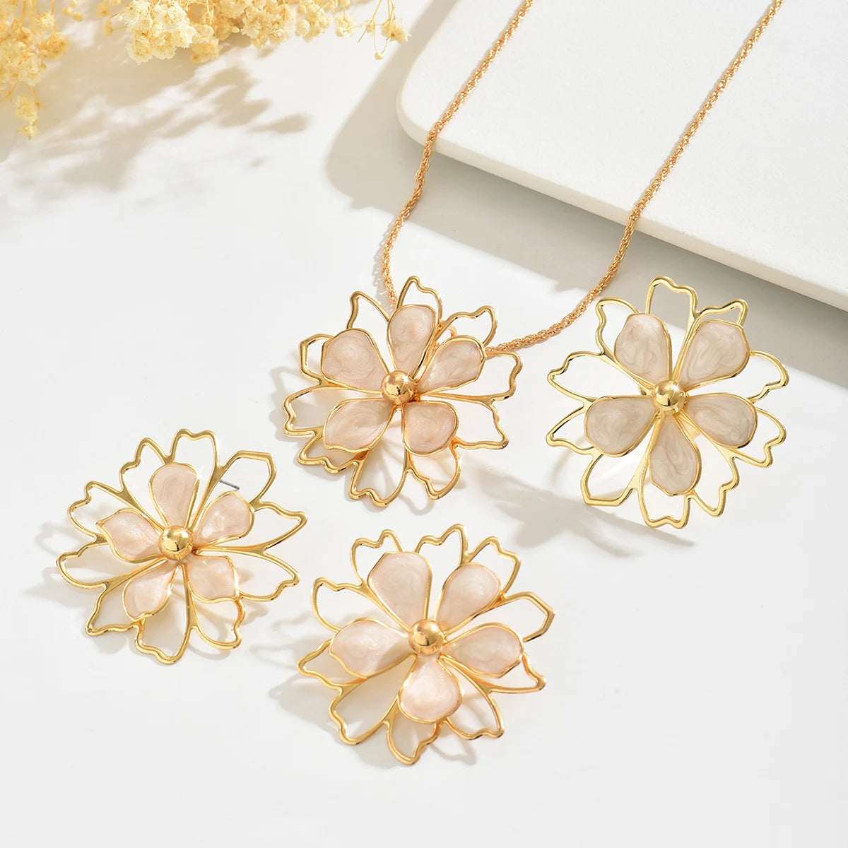 Bohemian floral jewelry set by MAIRA'S COLLECTIONS featuring floral necklace and matching earrings on a white background.