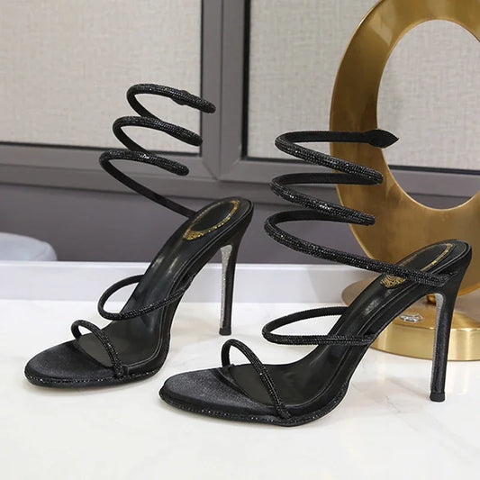 MAIRA'S COLLECTIONS Eilyken Crystal Ankle Strap High Heel Sandals with transparent heel and elegant design.