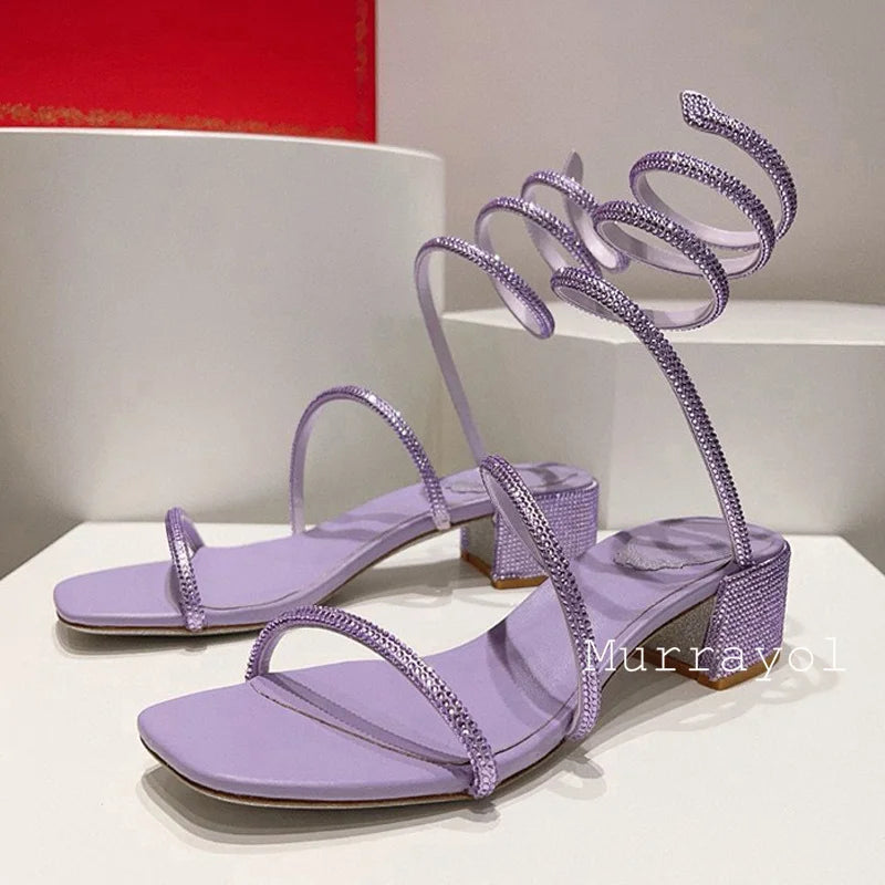 Women's rhinestone square heel sandals with elastic ankle strap by MAIRA'S COLLECTIONS, featuring sparkling embellishments and stylish design.