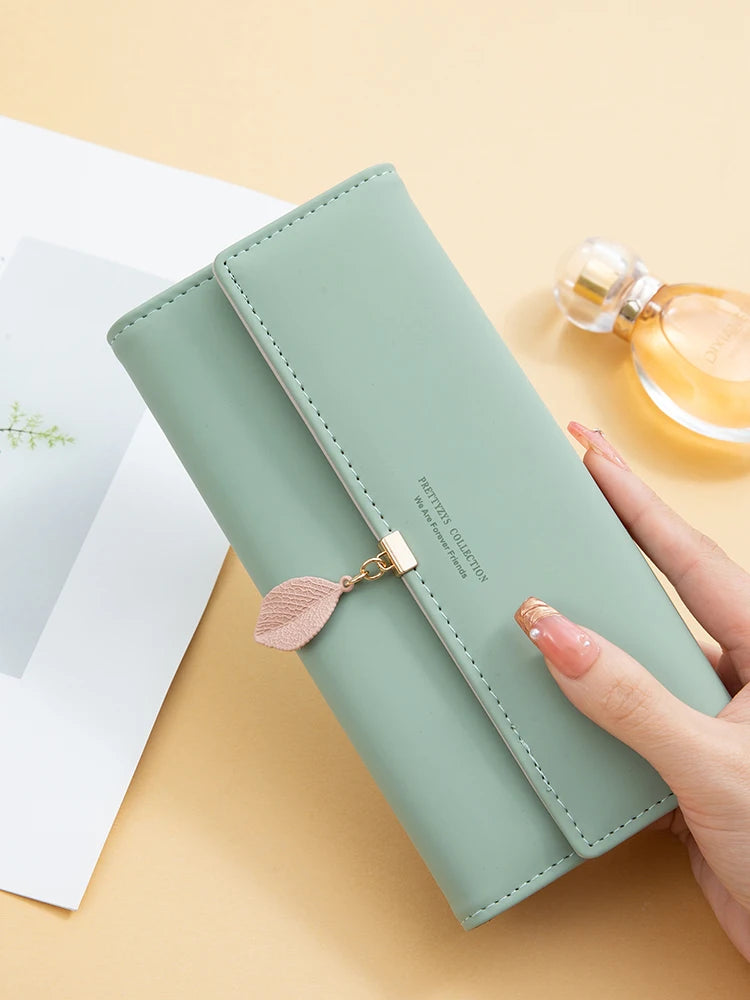Women's PU leather tri-fold bag by MAIRA'S COLLECTIONS featuring a sleek design and multiple compartments for versatile storage.