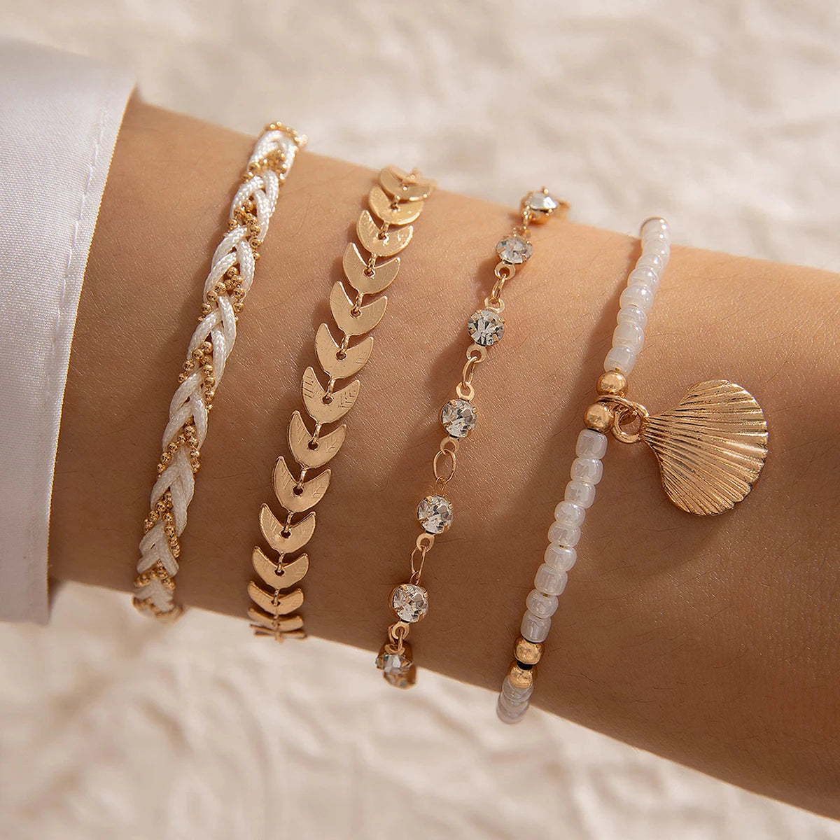 Tocona Bohemian Pearl Bracelet Set with 5pcs from MAIRA'S COLLECTIONS, featuring stylish pearl and bead designs on a natural setting.