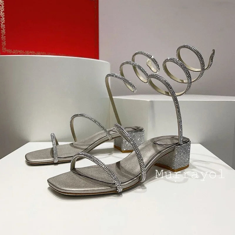 Women's rhinestone square heel sandals with elastic ankle strap by MAIRA'S COLLECTIONS, featuring sparkling embellishments and stylish design.