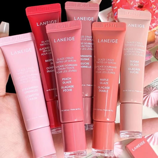 MAIRA'S COLLECTIONS Donut Lip Oil with strawberry, raspberry, and chocolate scents, showing a colorful donut-shaped lip balm.